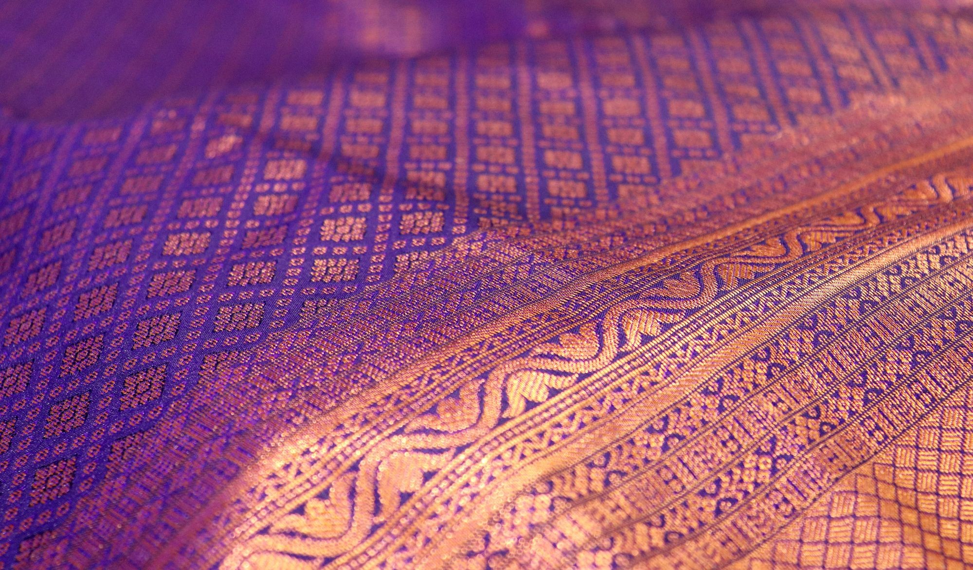 Close-up of a purple and gold silk weave