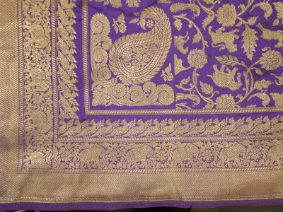 Purple Banarasi saree pallu with gold zari paisley motifs, laid flat
