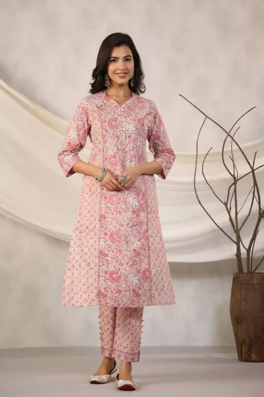 Woman in a pink floral block-printed A-line kurta with matching pants